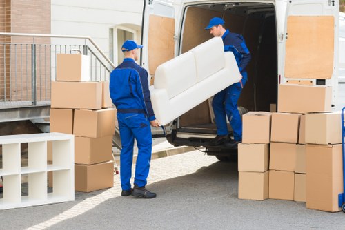 Removalists handling furniture with care during move